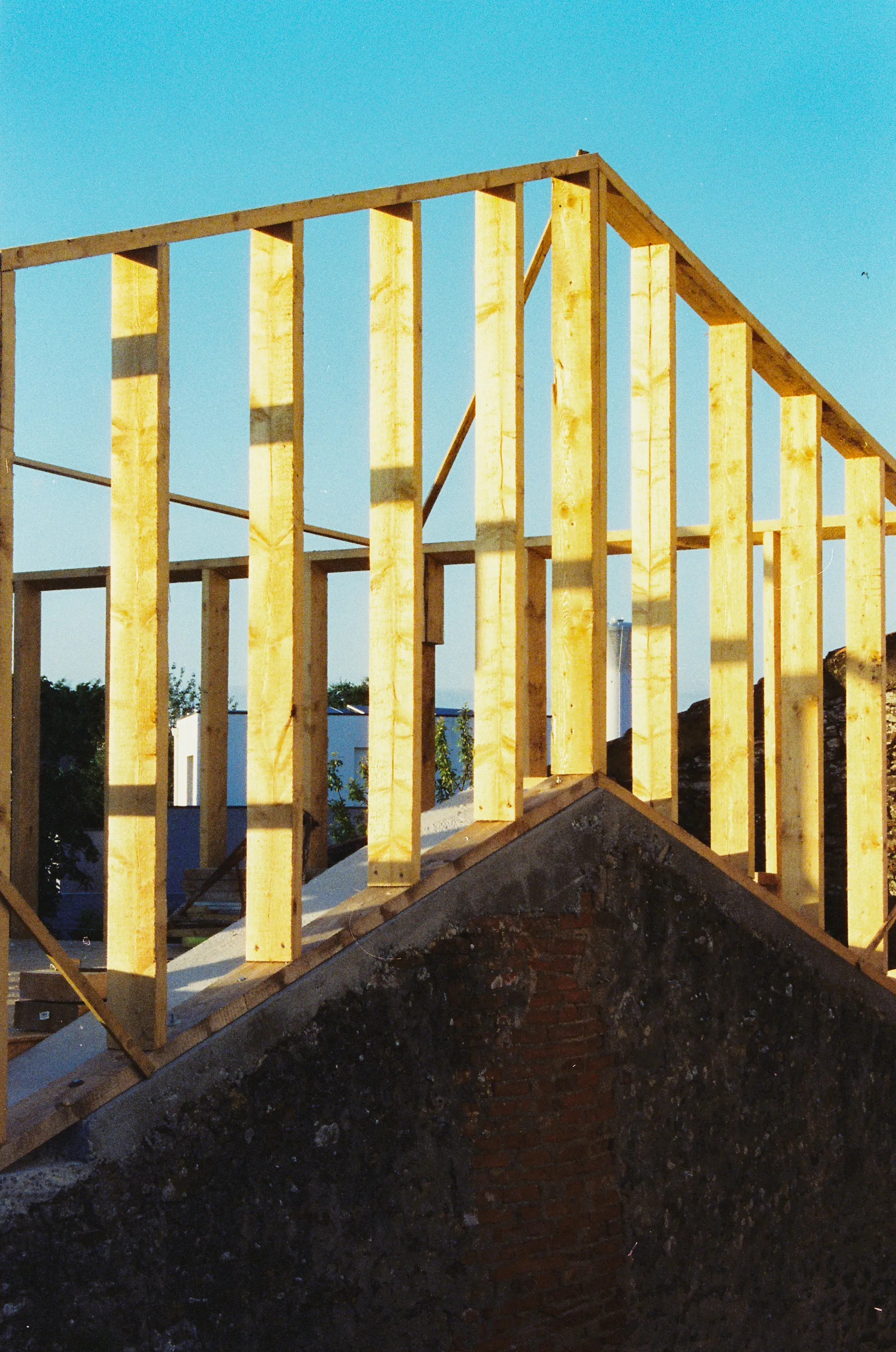 New wood stud walls framed above an existing gable for a second-story addition